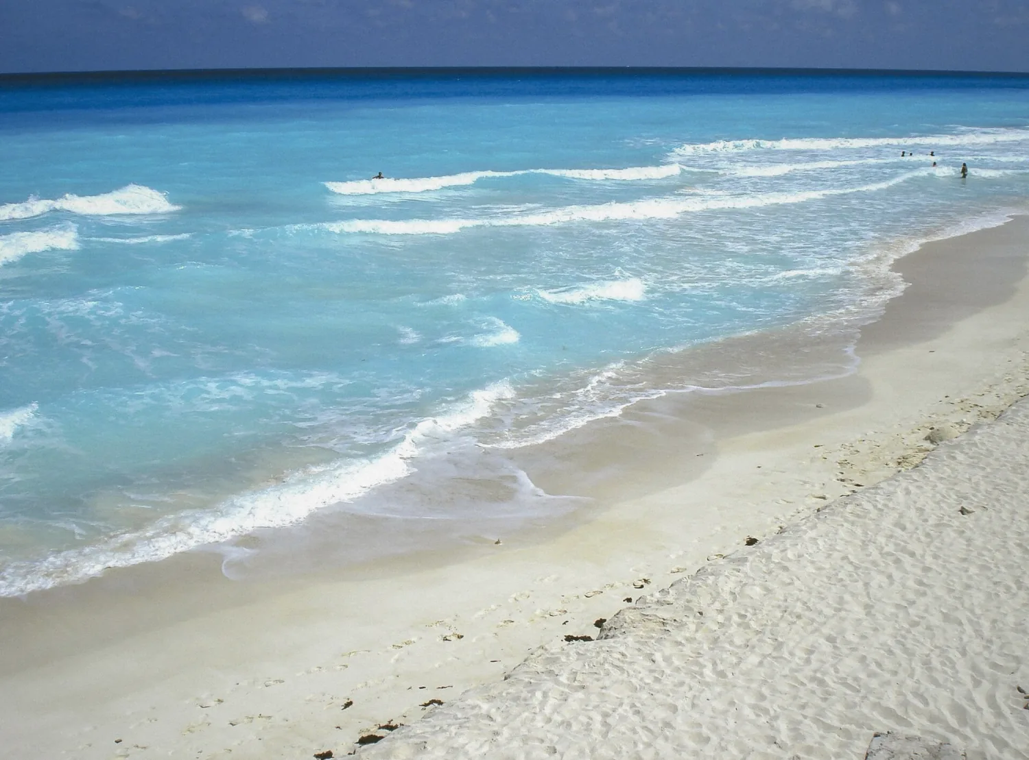 Wide white sand beach with turquoise Caribbean water at Playa Gaviota Azul in Cancun, Mexico